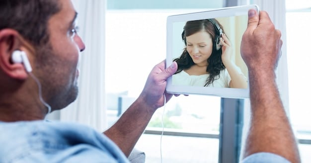 A person with a hearing impairment using a tablet with real-time AI-generated captions during a video call. The person is smiling and engaged in the conversation.