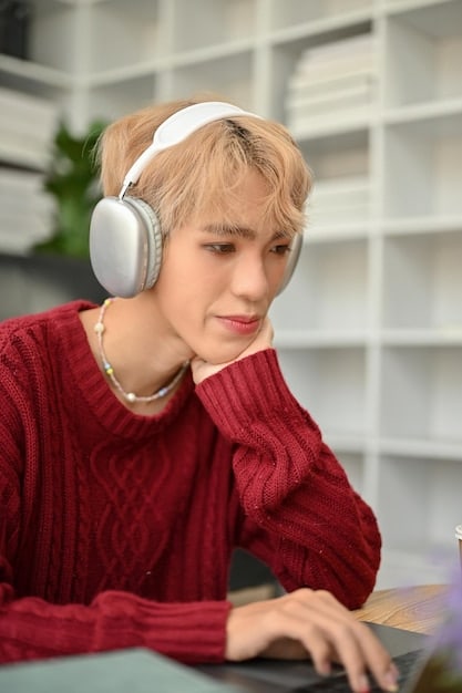 A young student wearing headphones and interacting with an AI tutor on a laptop. The AI tutor interface displays a lesson on fractions, with interactive elements and cheerful visuals. The student appears focused and engaged, with a positive expression.