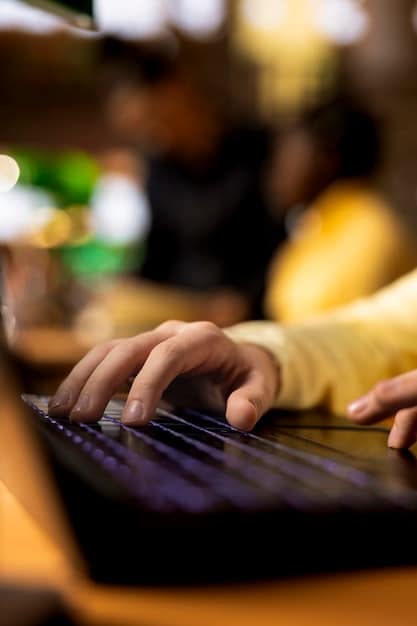 A close-up shot of hands coding on a laptop in a brightly lit, collaborative workspace. The focus is on the screen displaying complex code with AI-related libraries and frameworks, showcasing the technical skills required in AI research.