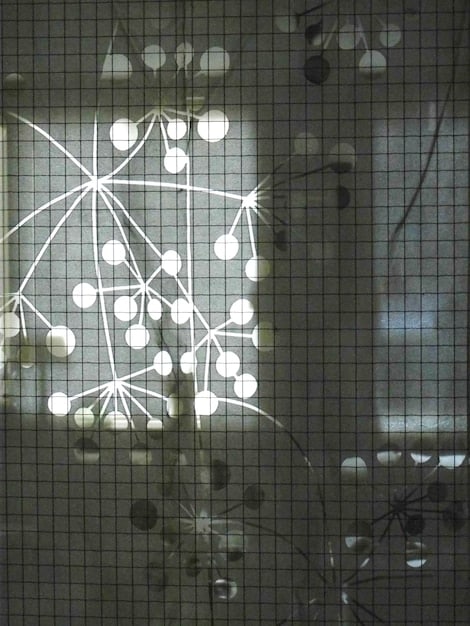A close-up of a computer screen showing complex data streams and algorithms. A magnifying glass hovers over the screen, highlighting anomalies and suspicious patterns in the data.